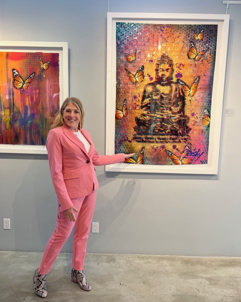 Christina LaManque presenting a contemporary Buddha artwork in a gallery