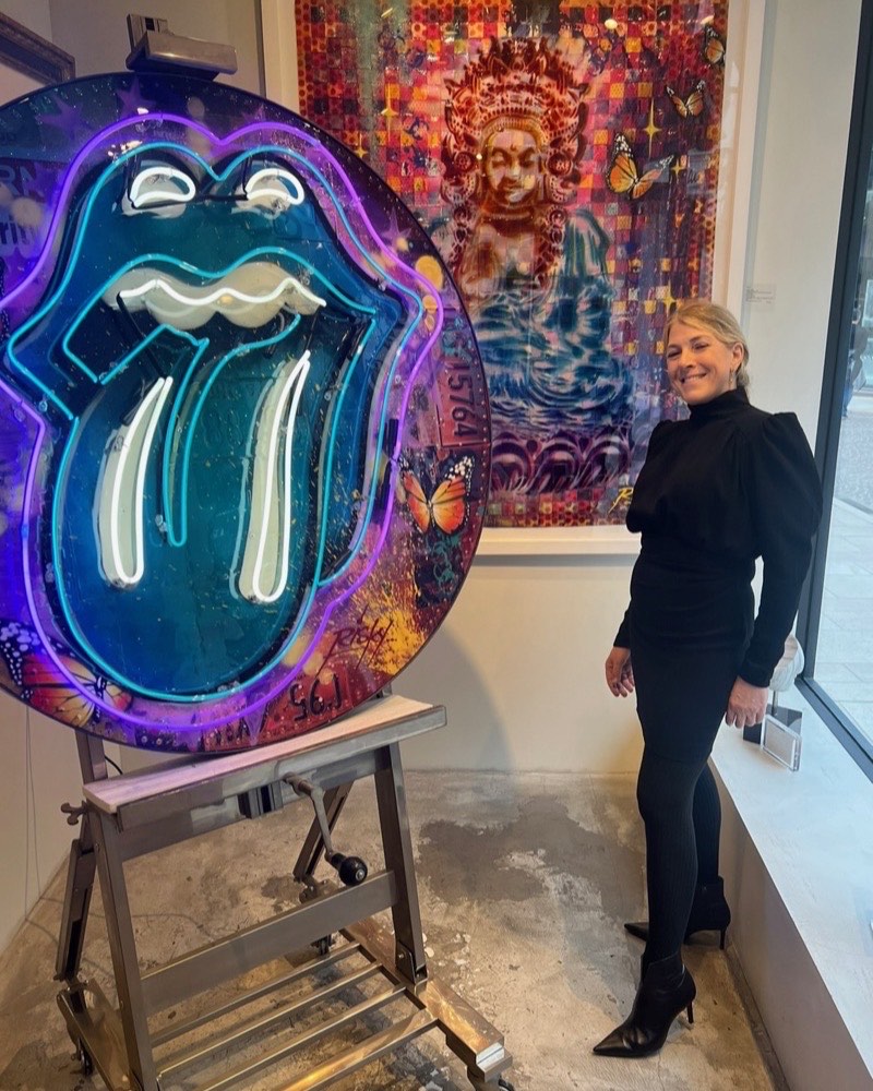 Christina LaManque beside a neon contemporary art piece