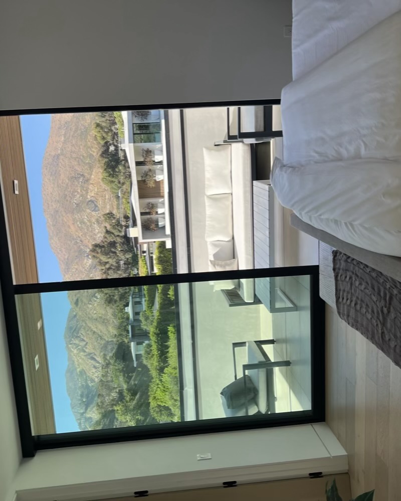 Bedroom opening to a terrace with canyon views