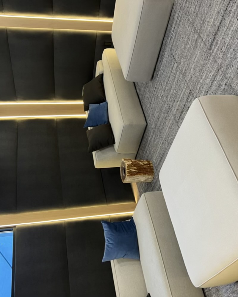 Media lounge with soft seating and warm accent lighting