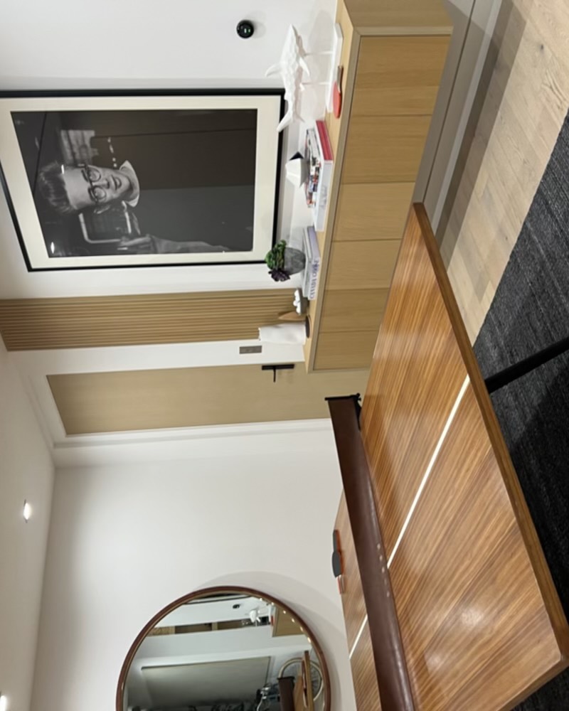 Living space with framed photography and a floating console
